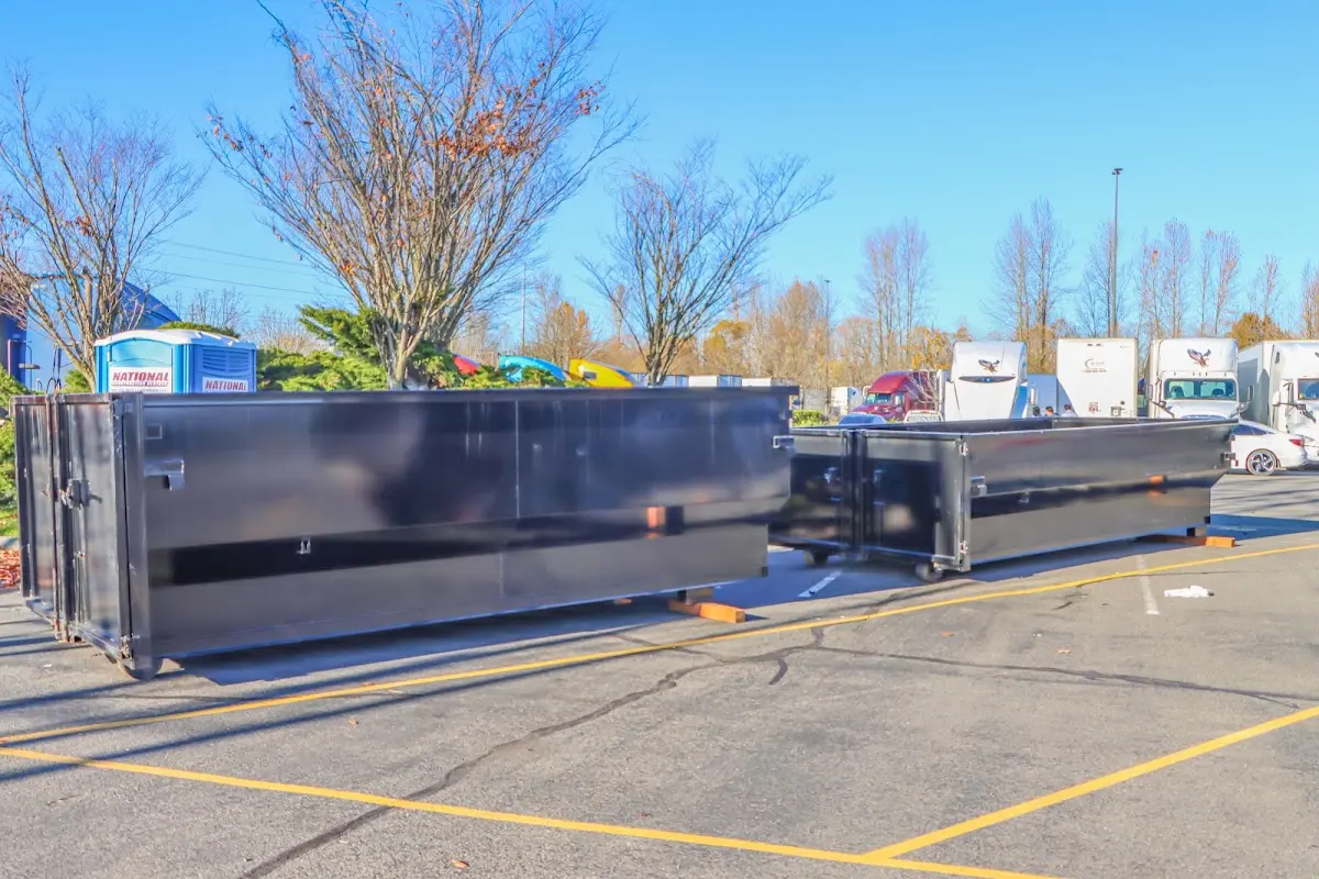 Professional dumpster rental service with roll-off container on residential driveway in Connersville